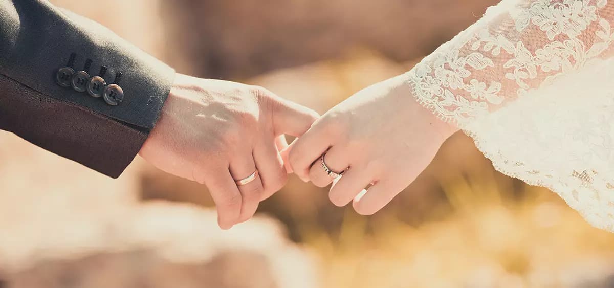 تصویری از دست یک عروس و داماد در دست هم